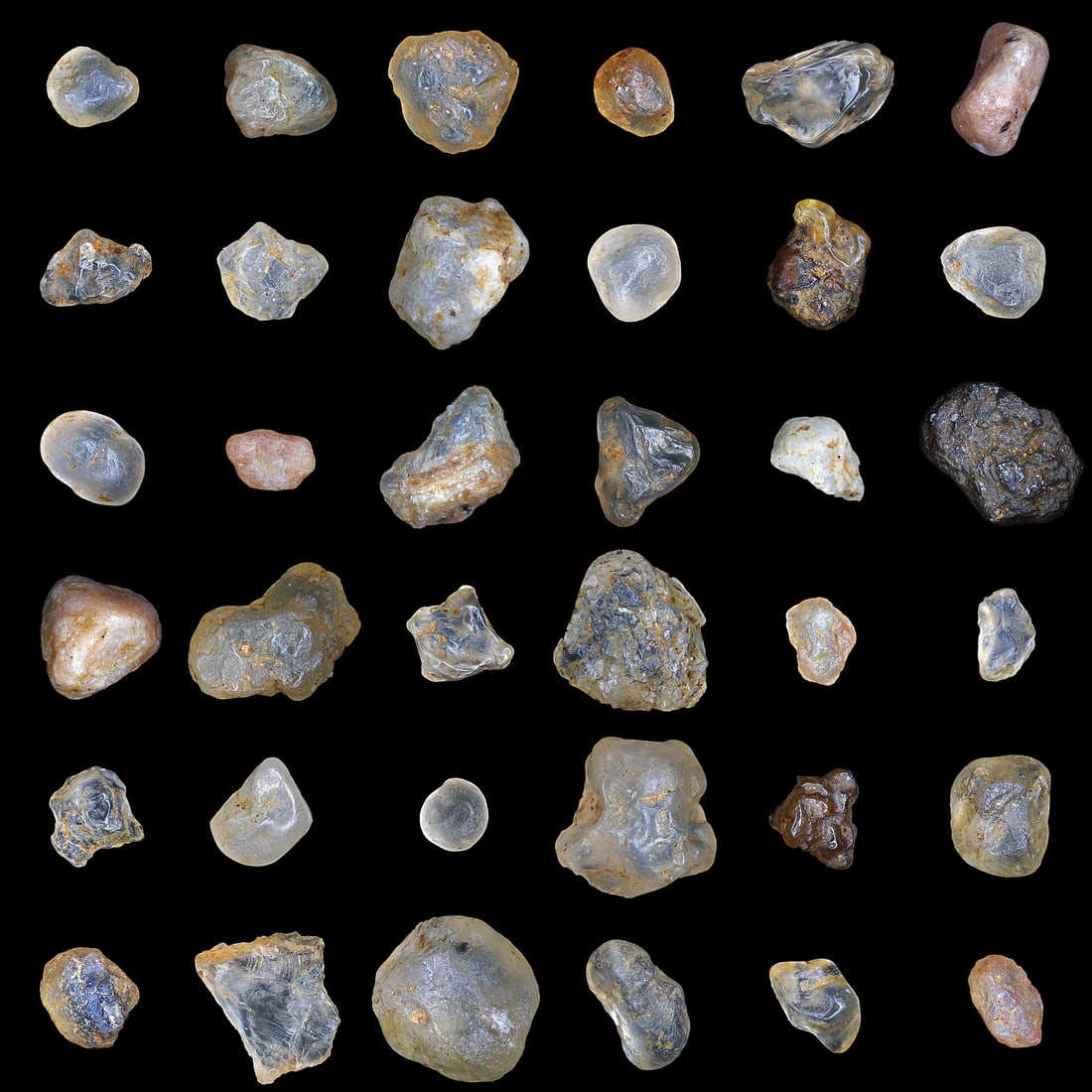Individual sand grains enlarged and arranged against a dark background.