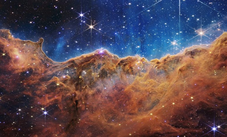 Webb’s Cosmic Cliffs in NGC 3324, using assigned colours to display infrared observations.