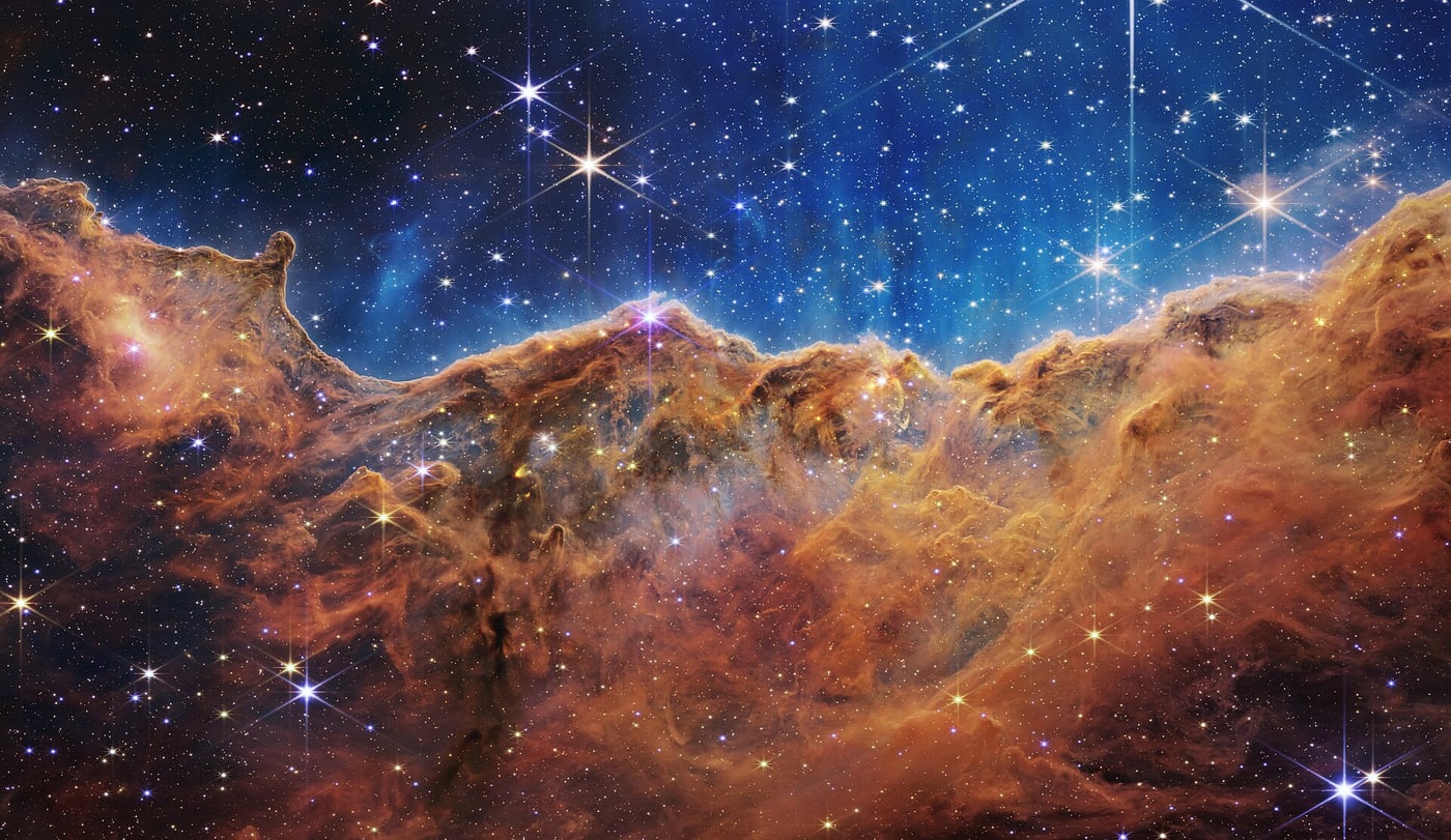 Webb’s Cosmic Cliffs in NGC 3324, using assigned colours to display infrared observations.